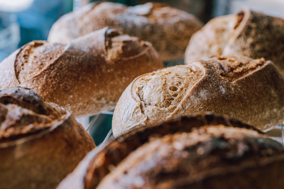 Rustic artisanal bread loaves with golden crusts displayed in a Buenos Aires bakery.