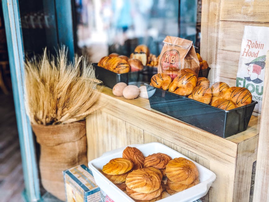 A bakery window featuring fresh pastries and artisanal flour, creating a warm and inviting atmosphere.